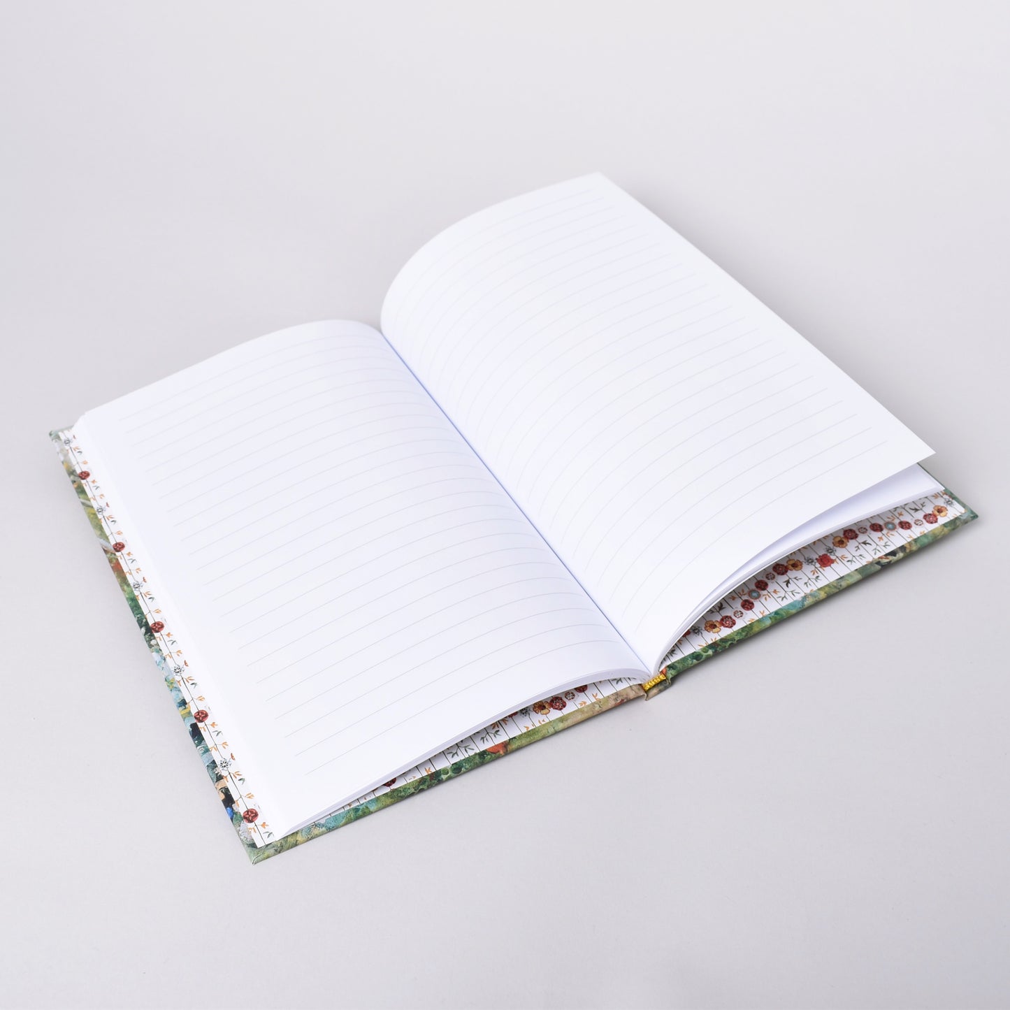 Linjerade sidor i anteckningshäfte med Carl Larsson motiv