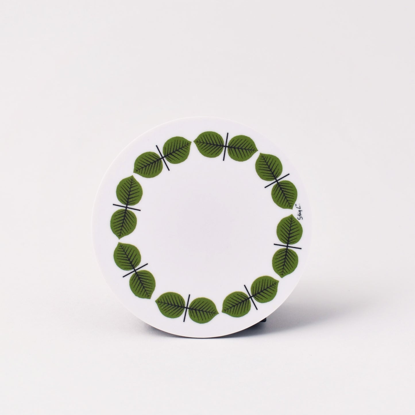 vitt och rundt glasunderlägg med mönstret Berså 