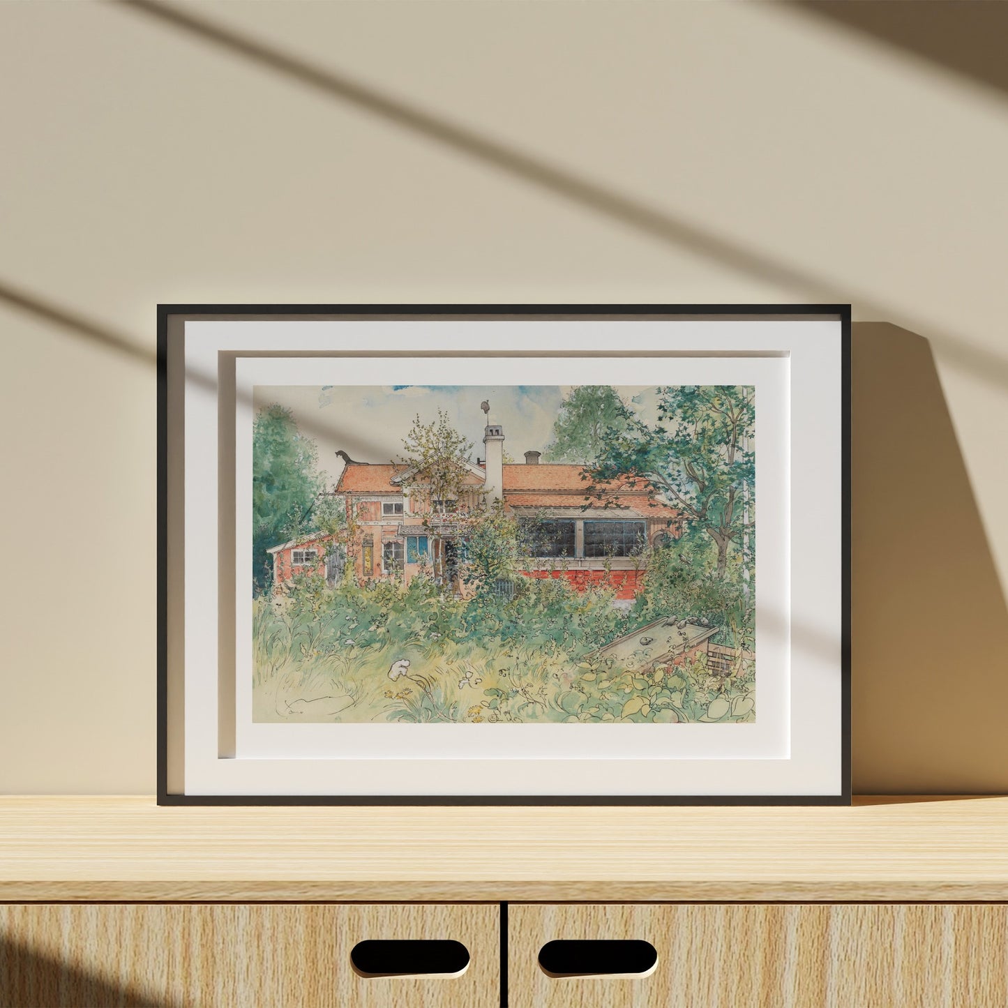 Poster i svart ram med Carl Larssons akvarell Stugan från Nationalmuseum