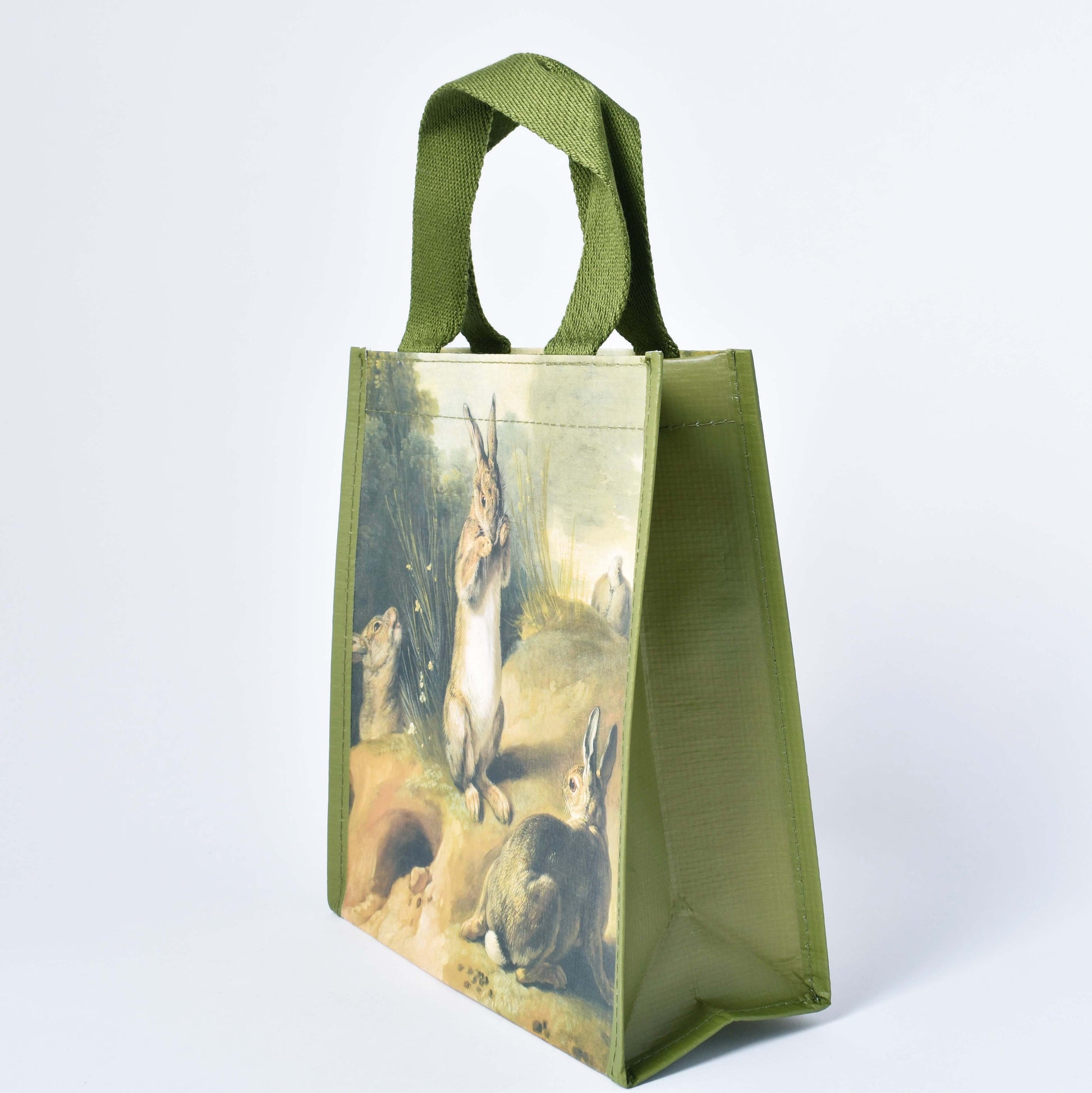 Shoppingkasse med kaninmotiv och grönt handtag