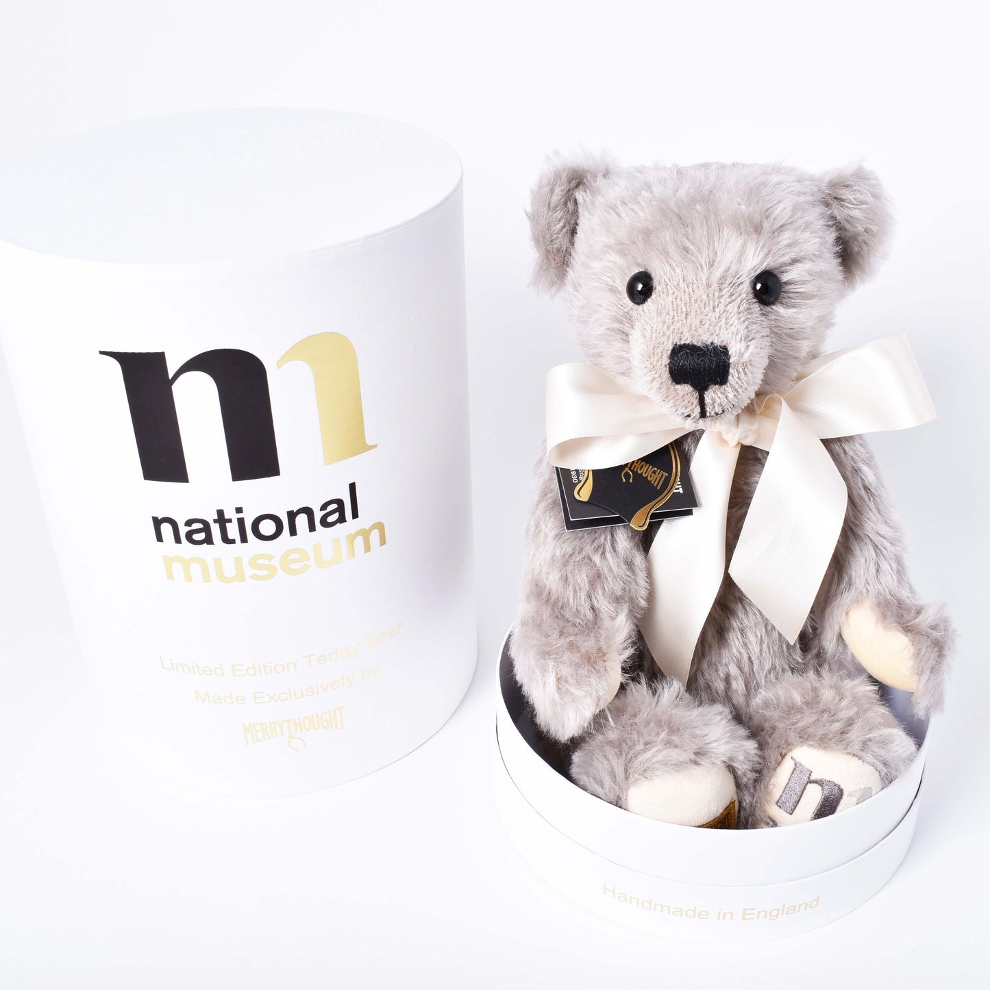 Exklusiv grå och mjuk nalle med vit rosett och ask med Nationalmuseums logga