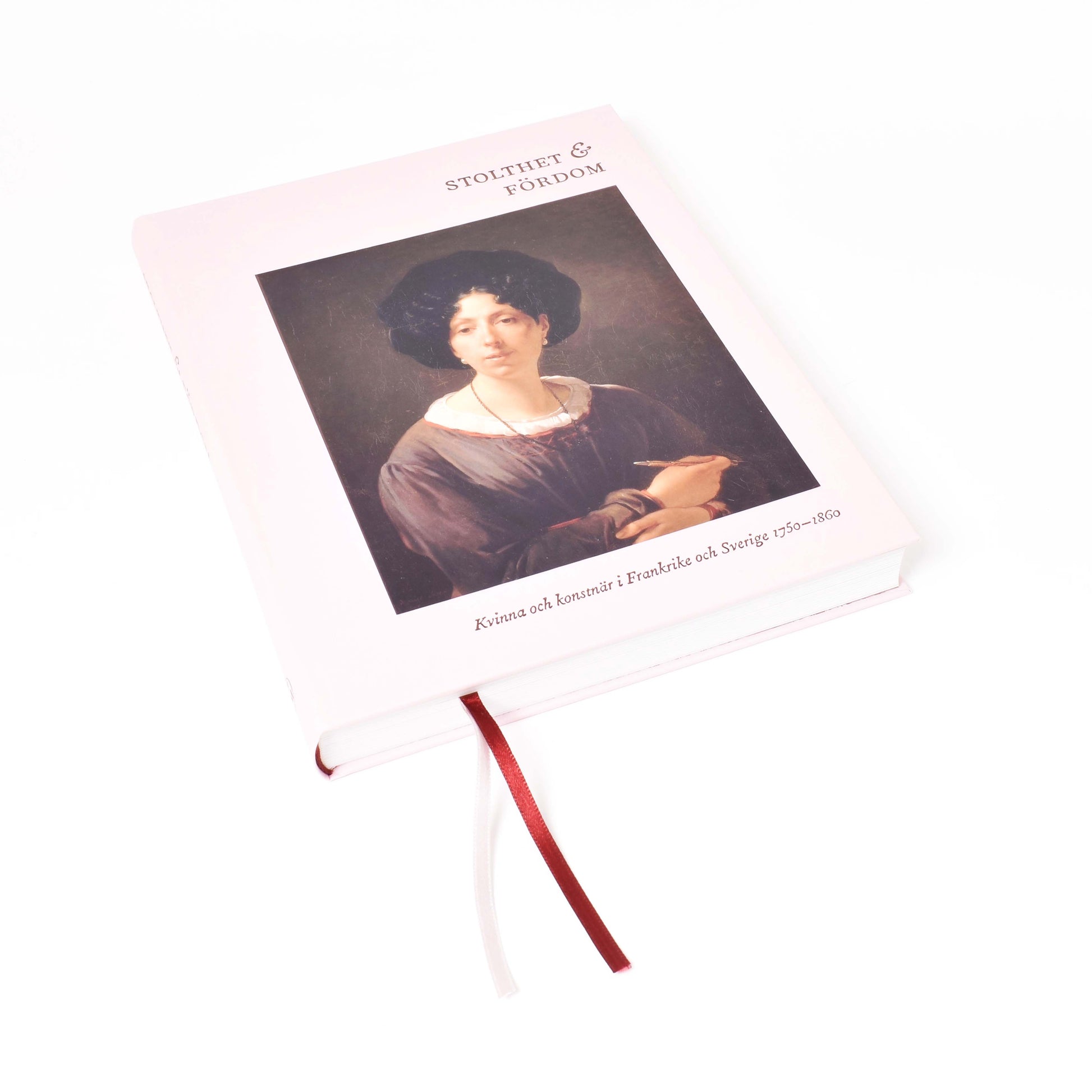 Framsida till boken "stolthet & fördom-kvinna och konstnär" med rosa pärm 